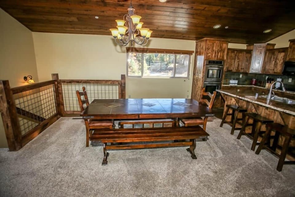 Wood table and rustic overhead chandelier.