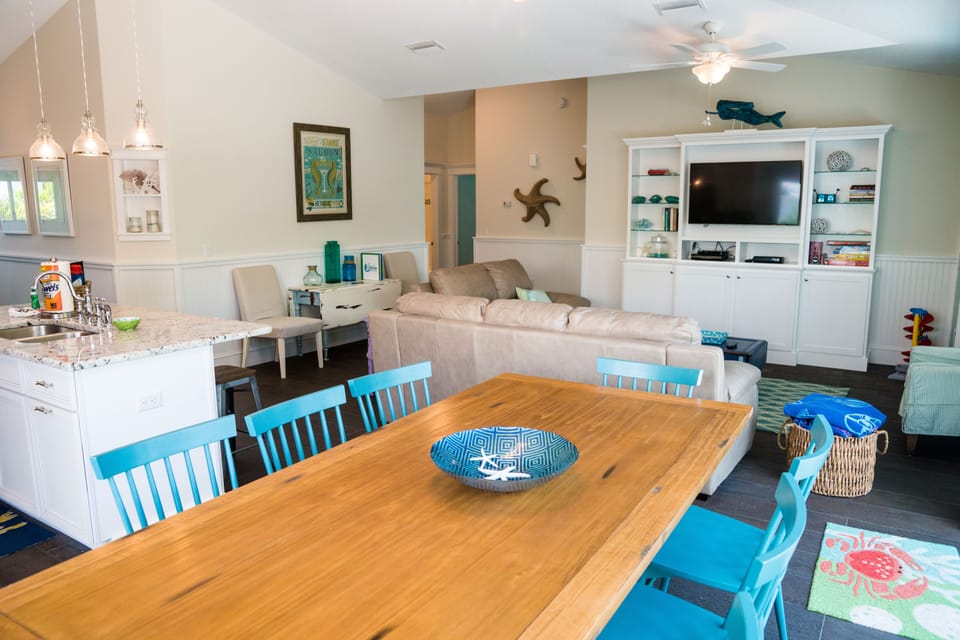 Large dining room table overlooking the living room and kitchen
