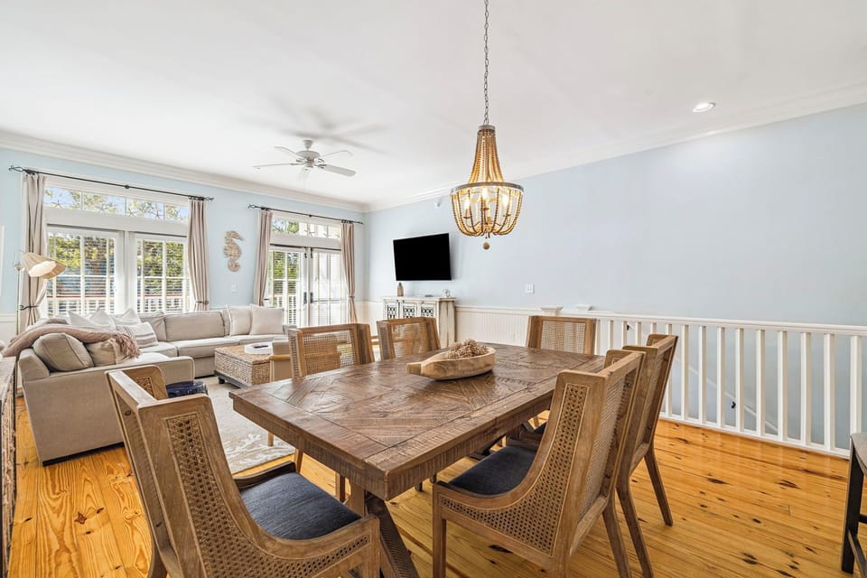 Gather around this stunning dining table where natural light streams through elegant windows, creating the perfect setting for memorable meals together.