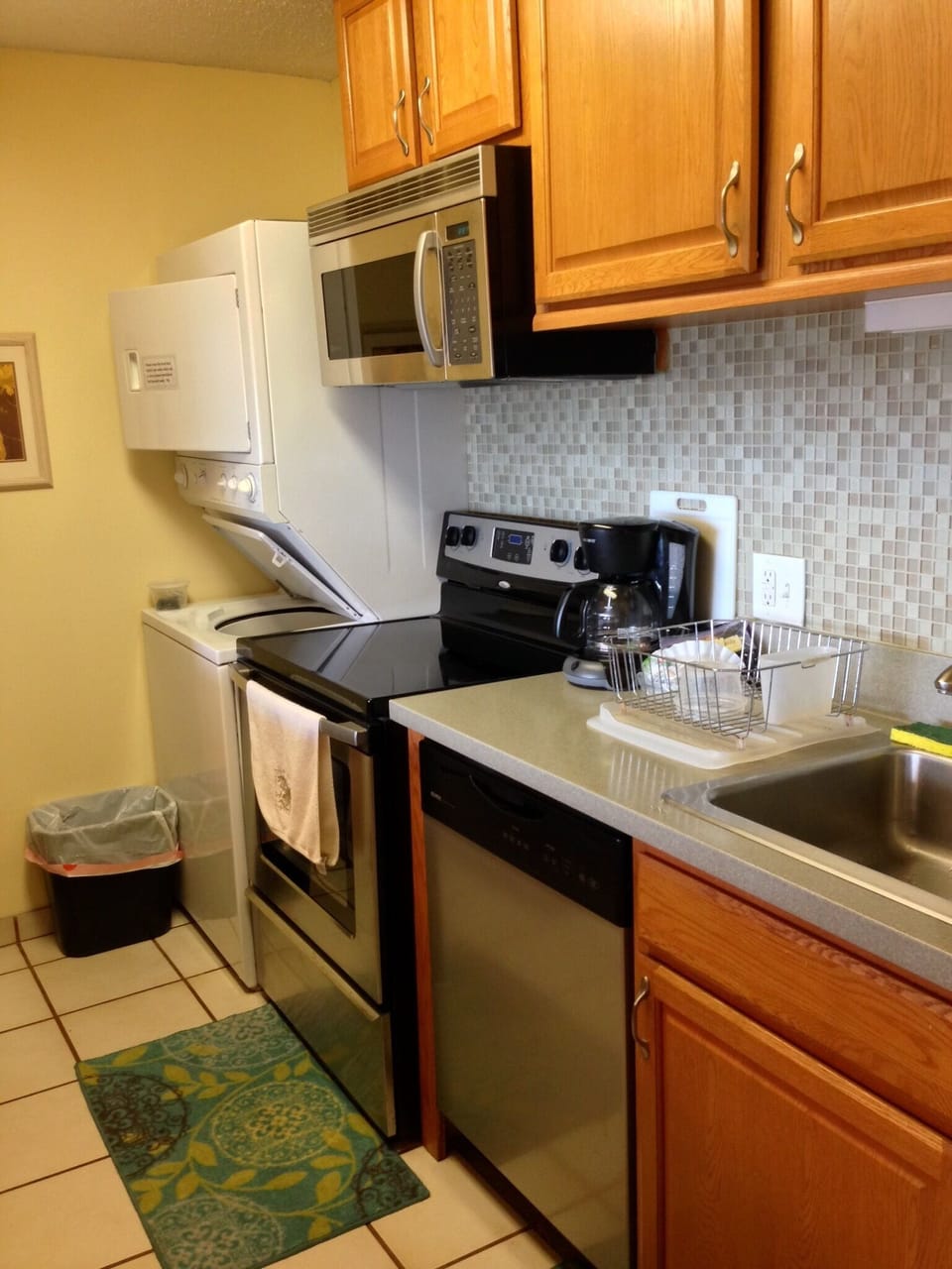 Your fully equipped kitchen has everything you need to prepare meals during your stay, with modern appliances, ample counter space, and warm wood cabinetry creating a welcoming cooking environment.