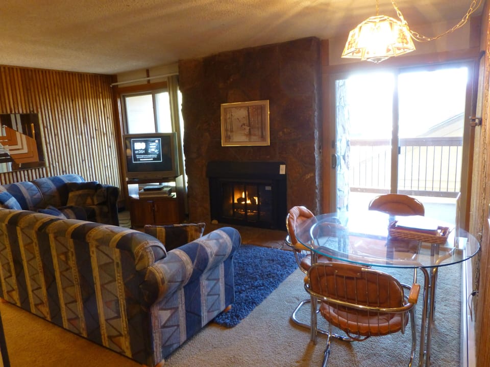 Living Room with gas Fireplace, small dining table.  