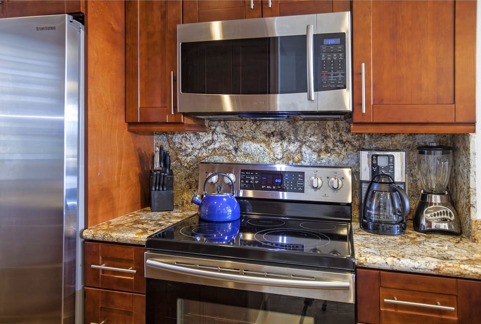 Your fully equipped kitchen features stainless steel appliances, granite countertops, and everything you need to prepare meals—from coffee maker to microwave to stove.