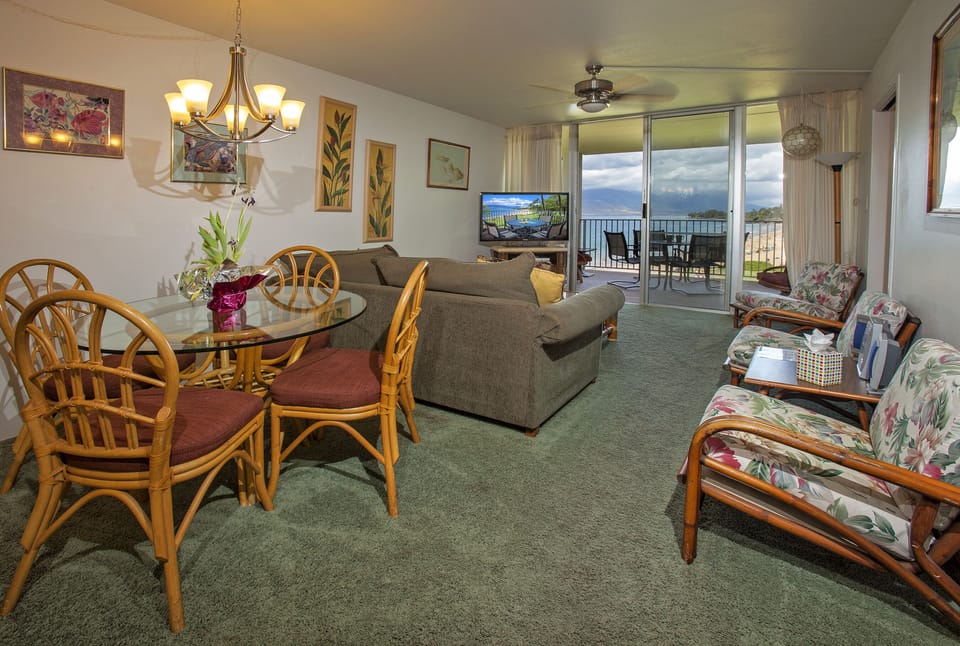 Step into your bright, welcoming living space where a plush sofa invites you to relax and floor-to-ceiling windows frame spectacular ocean views from your private balcony.