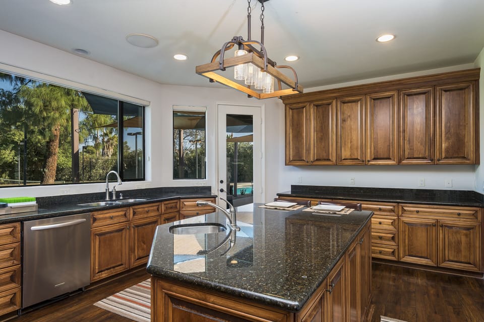 Huge Kitchen with door access to back patio area.