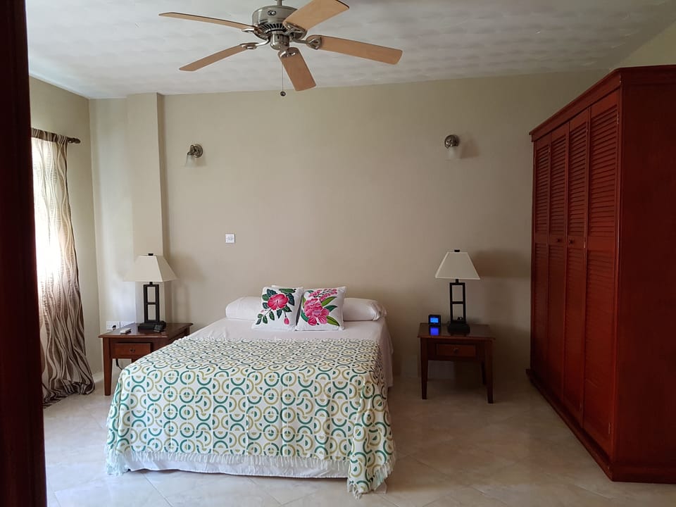 Bedroom 1 with King Size bed, ceiling fan, AC Unit and closet