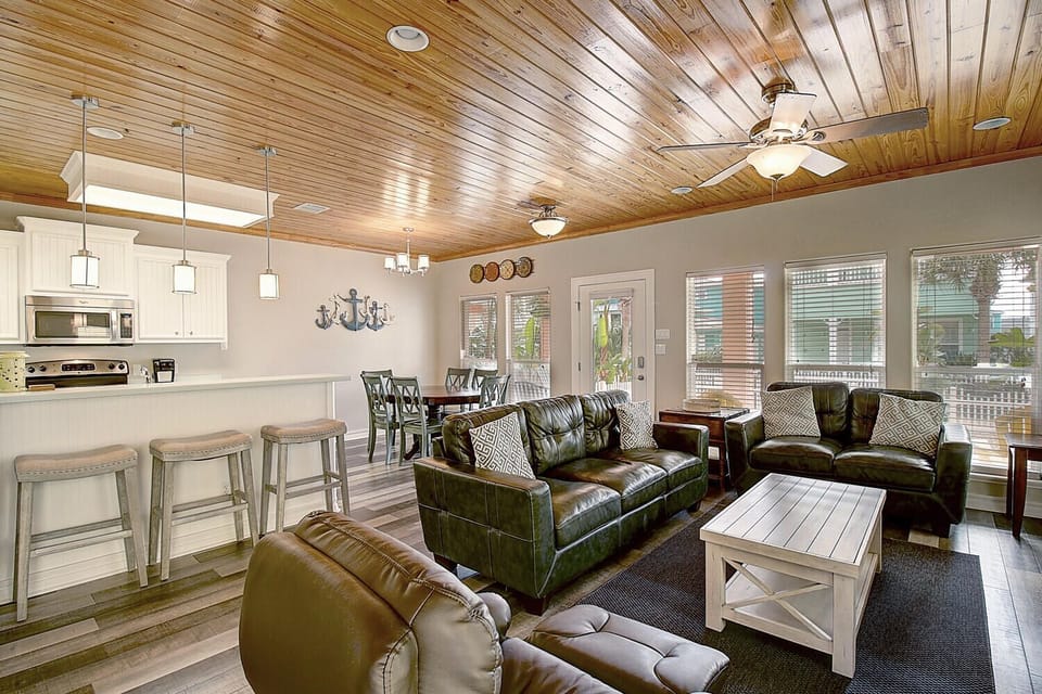 Unwind in this beautifully designed open-concept space where rustic wood ceilings meet modern comfort, perfect for your group gatherings.