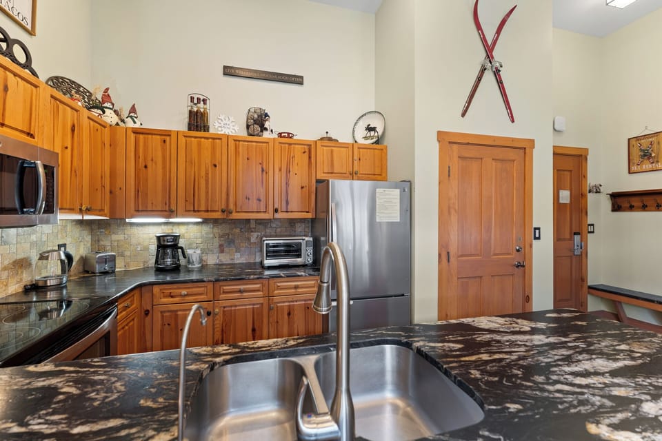 Your fully equipped kitchen features granite counters, stainless appliances, and rustic charm for memorable mountain meal preparation.