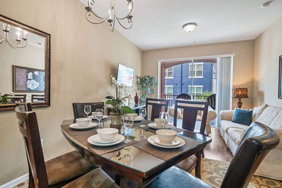 Charming Dining Area of the Apartment in Orlando Florida - 4 Persons Dining - Quality materials, such as a sleek dining table and comfortable chairs - Modern Design - Intimate ambiance created through soft, ambient lighting
