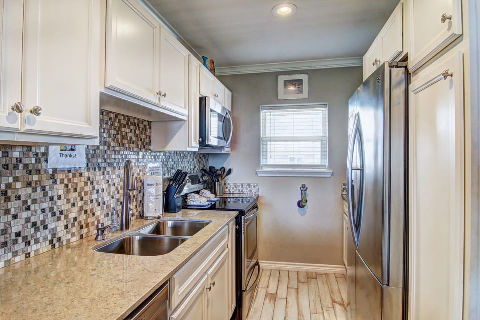 Your fully equipped kitchen awaits with modern appliances and elegant finishes, perfect for preparing meals during your stay.