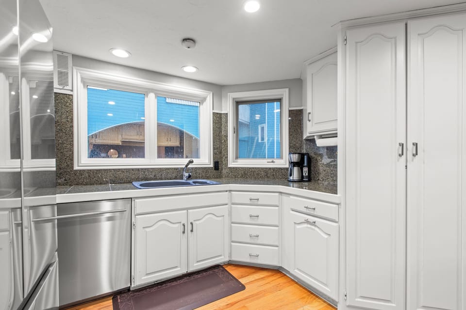 A fully equipped kitchen with granite countertops, stainless steel appliances, and plenty of storage.
