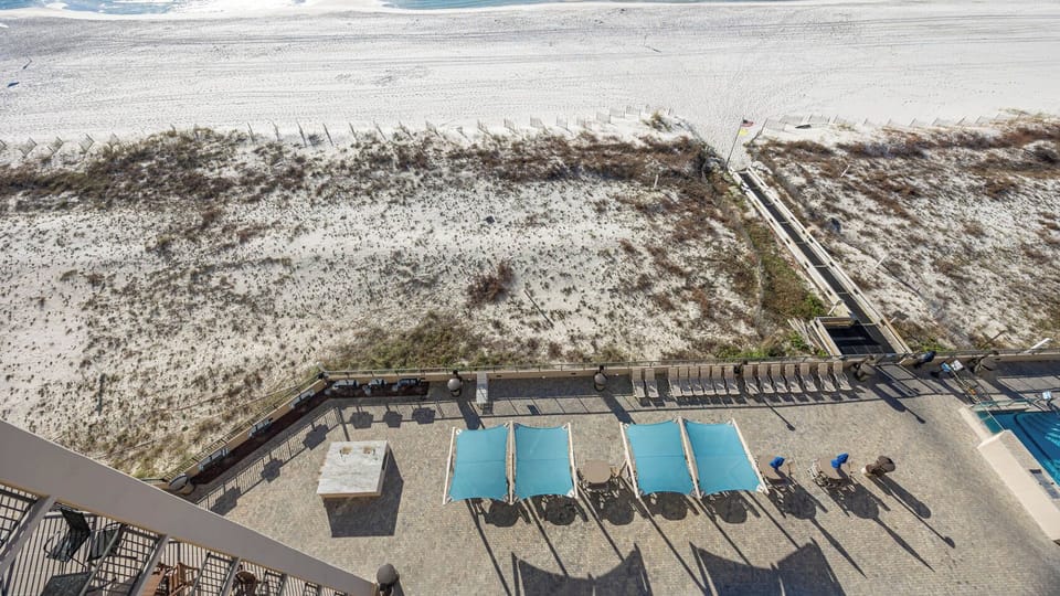 Relax on the spacious patio pool area with shaded seating, perfect for enjoying the view and fresh air