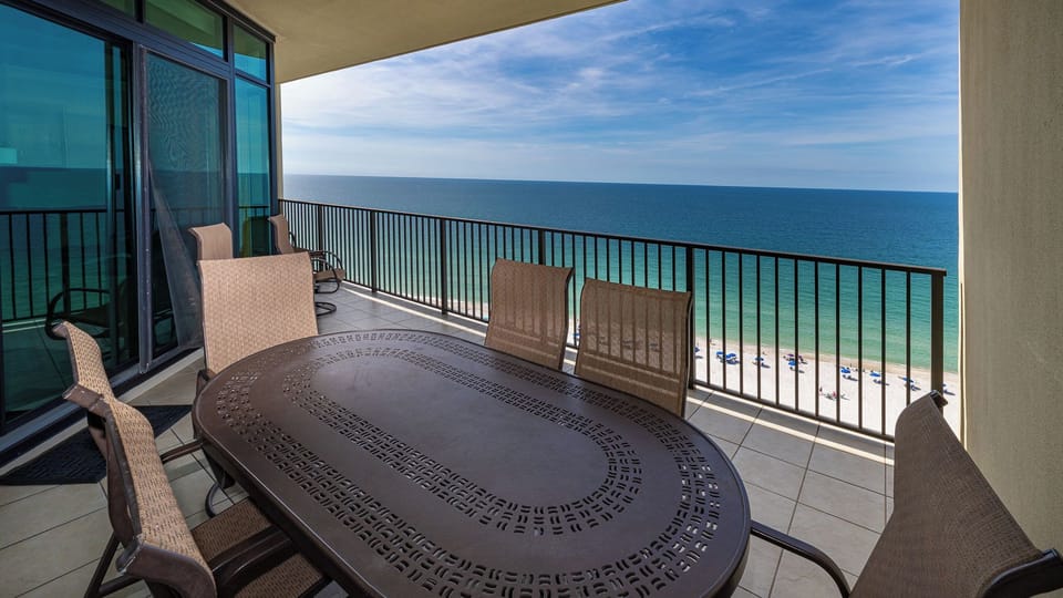 Your balcony invites you to savor coastal breezes while seated around a large table with chairs