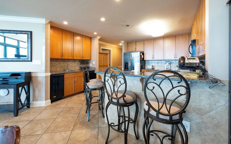 Gather around the breakfast bar in the kitchen and create lasting memories with morning coffee
