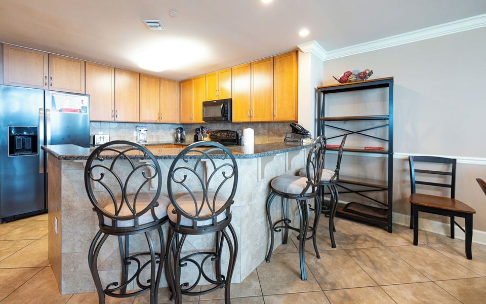 In the kitchen, sip coffee at the breakfast bar while planning your beach day