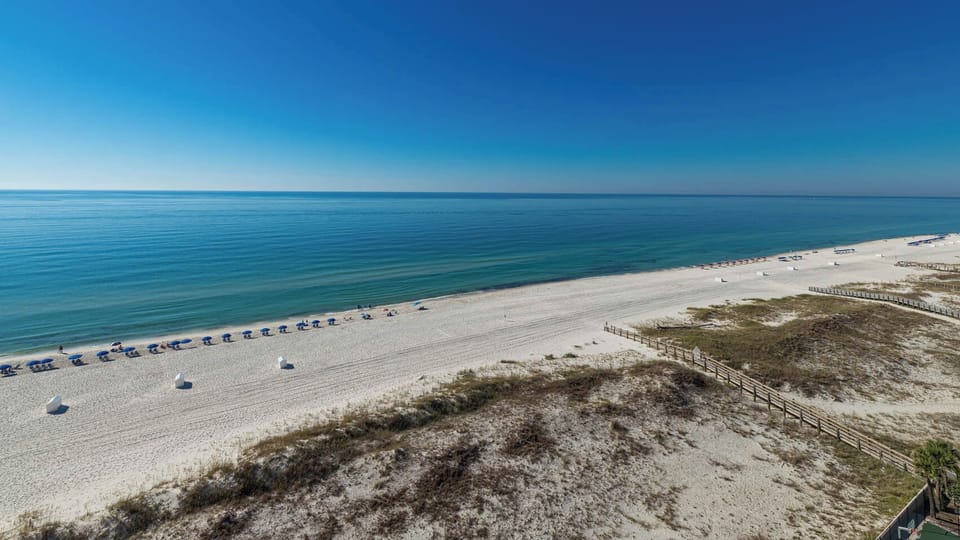 Gaze at the tranquil waters and beach chairs lined up for a perfect day of relaxation and sunbathing
