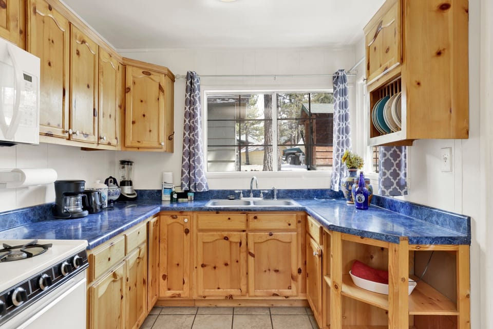 Fully equipped cabin kitchen with ample cabinetry, stove, fridge, microwave, and coffee maker—perfect for cooking meals, morning coffee, and feeling right at home on your stay.