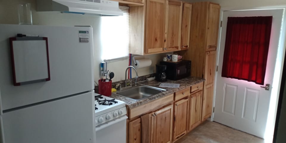 Full kitchen with stove, microwave, coffee maker, pots, pans even a blender!