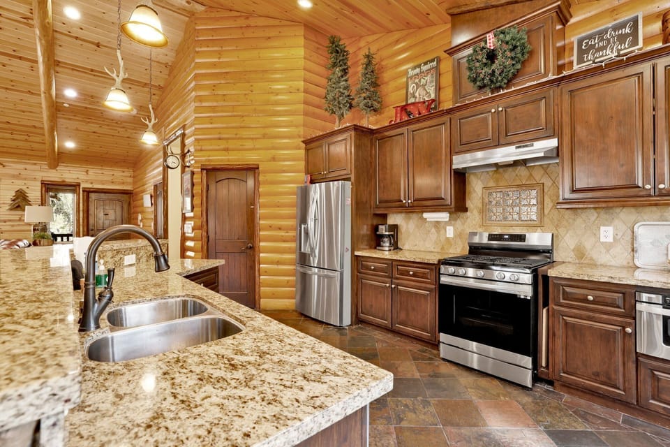 Fully equipped cabin kitchen with ample cabinetry, stove, fridge, microwave, and coffee maker—perfect for cooking meals, morning coffee, and feeling right at home on your stay.
