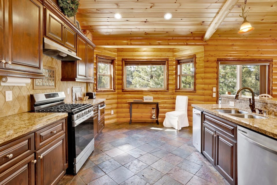 Fully equipped cabin kitchen with ample cabinetry, stove, fridge, microwave, and coffee maker—perfect for cooking meals, morning coffee, and feeling right at home on your stay.