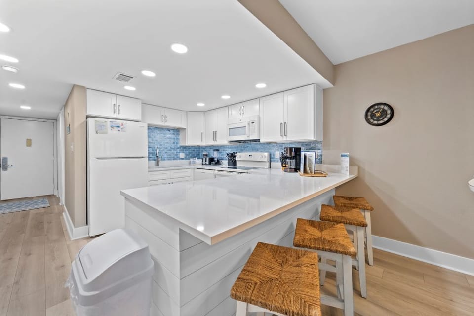 Your fully-equipped kitchen invites culinary adventures with gleaming countertops, modern appliances, and a spacious island perfect for morning coffee or meal prep.