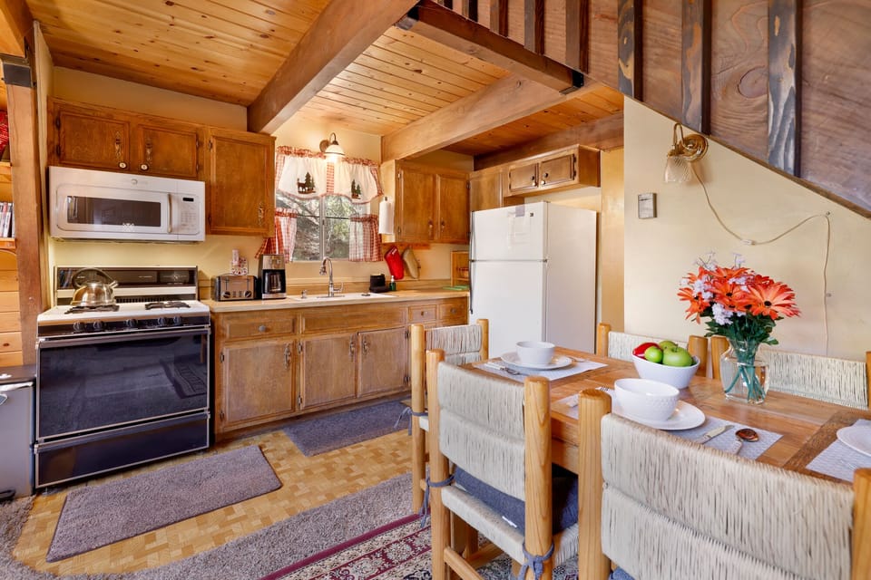 Fully equipped cabin kitchen with ample cabinetry, stove, fridge, microwave, and coffee maker—perfect for cooking meals, morning coffee, and feeling right at home on your stay.