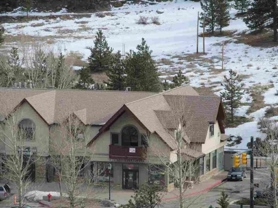 The outside of the condo with open space behind. 