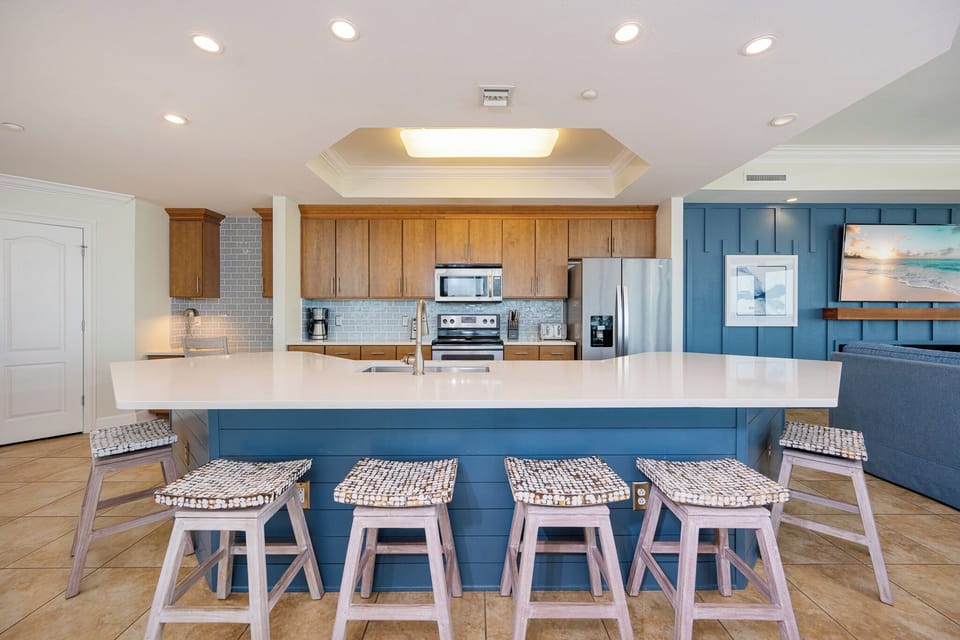 Enjoy lively conversations at the inviting breakfast island, where family moments come alive in this inviting kitchen