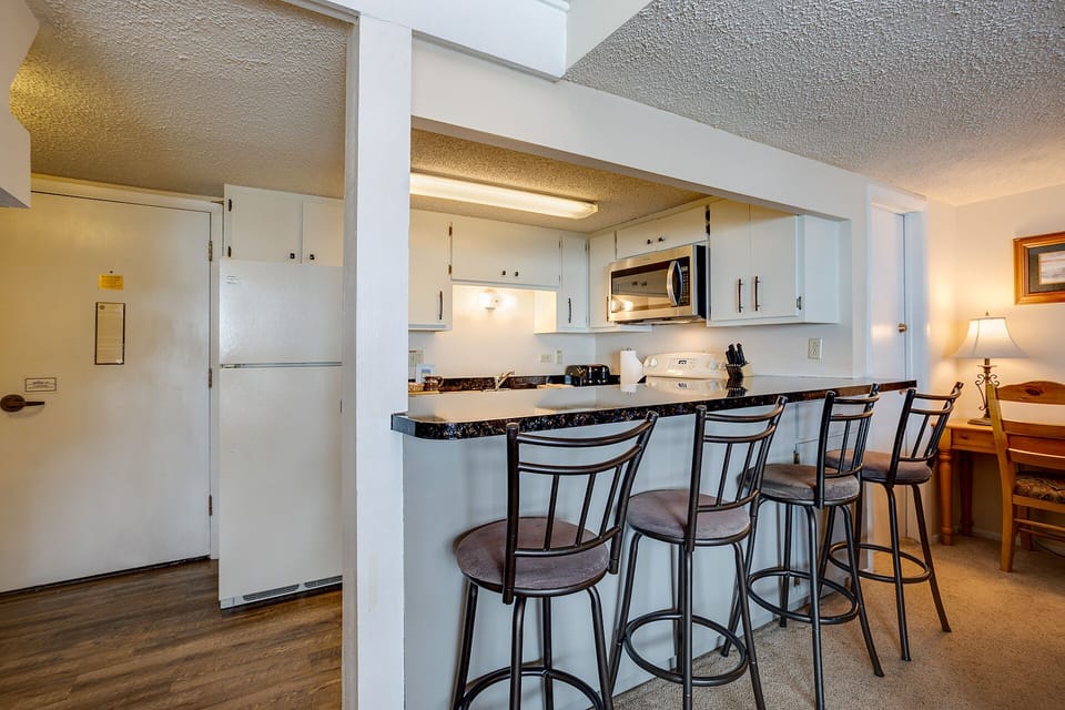 Your fully equipped kitchen features granite countertops and breakfast bar seating for memorable mornings and convenient meal prep.