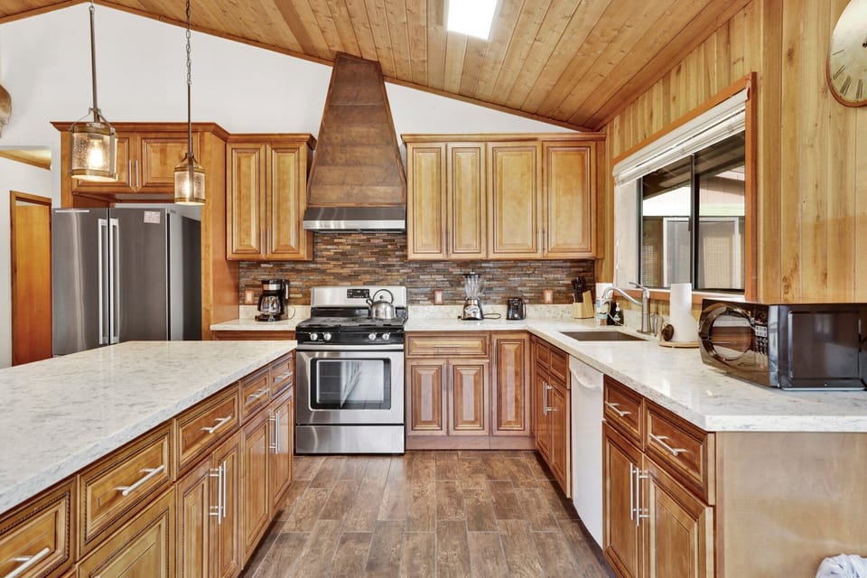 Fully equipped cabin kitchen with ample cabinetry, stove, fridge, microwave, and coffee maker—perfect for cooking meals, morning coffee, and feeling right at home on your stay.