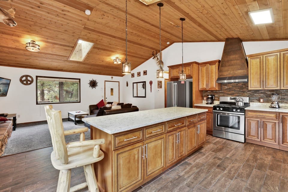 Fully equipped cabin kitchen with ample cabinetry, stove, fridge, microwave, and coffee maker—perfect for cooking meals, morning coffee, and feeling right at home on your stay.