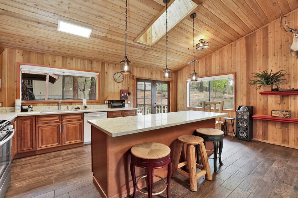 Fully equipped cabin kitchen with ample cabinetry, stove, fridge, microwave, and coffee maker—perfect for cooking meals, morning coffee, and feeling right at home on your stay.