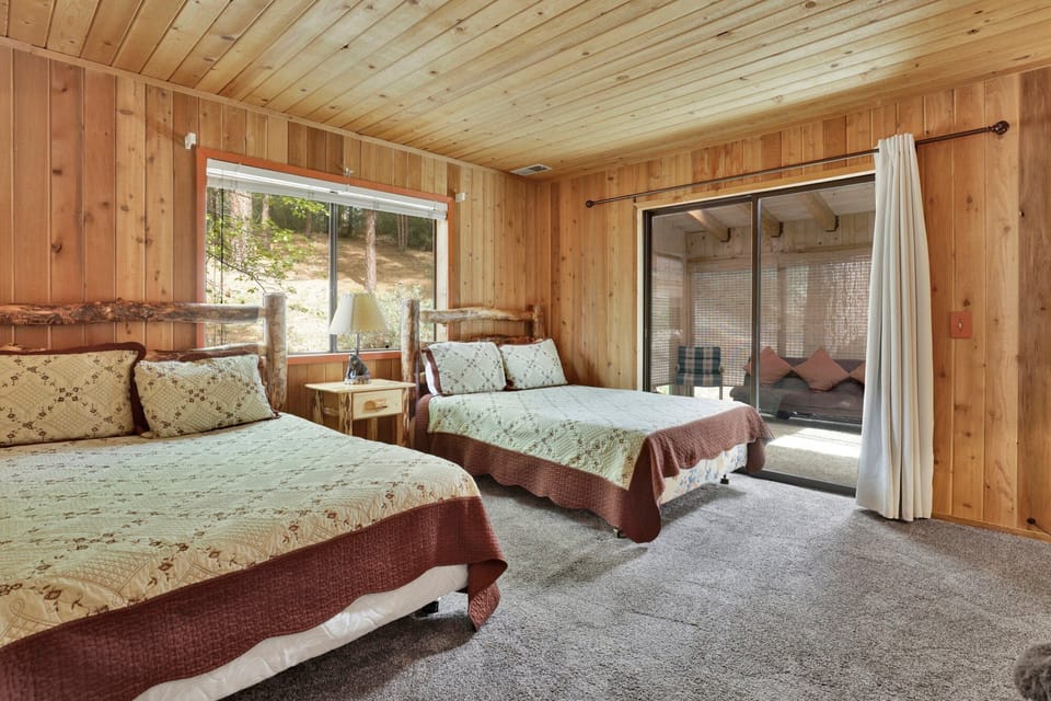 Peaceful cabin bedroom with plush bedding, and beautiful views—ideal for restful nights, cozy mornings, and a relaxing mountain escape.