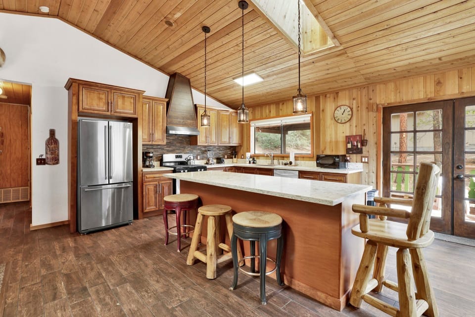 Fully equipped cabin kitchen with ample cabinetry, stove, fridge, microwave, and coffee maker—perfect for cooking meals, morning coffee, and feeling right at home on your stay.