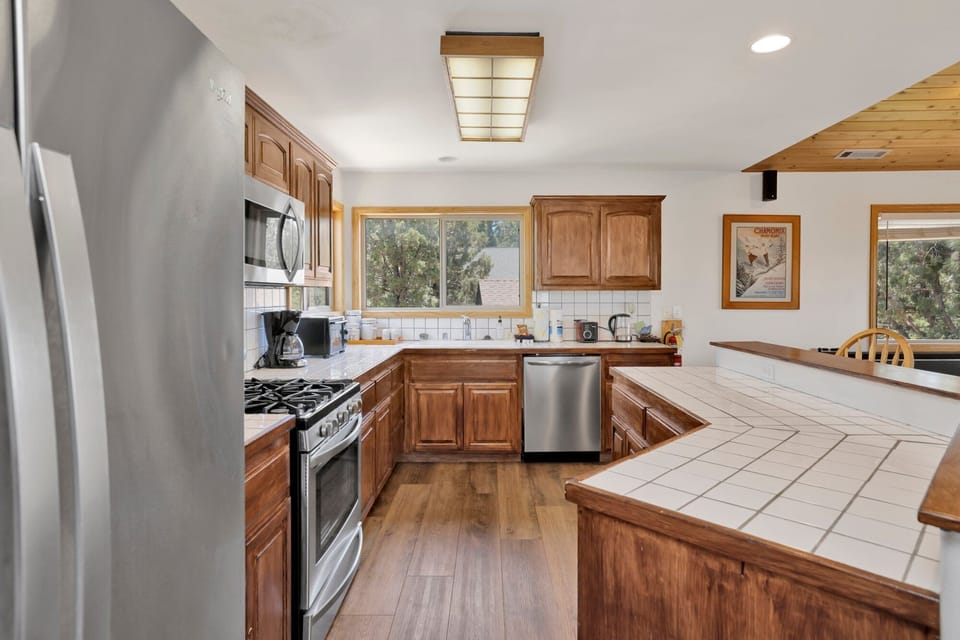 This well-equipped kitchen features beautiful wood cabinetry and modern stainless steel appliances.