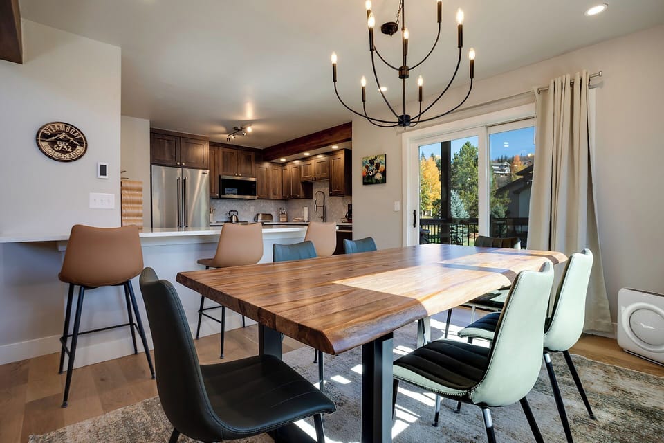 Gather around this beautiful wood dining table where your group can share meals and create memories together in this elegant, light-filled space.
