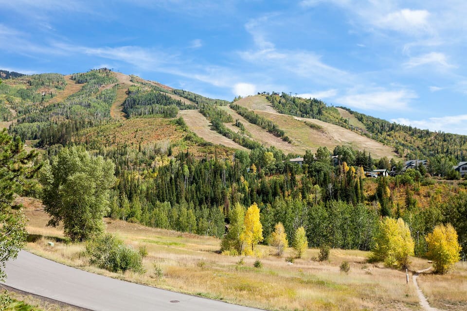 Mountain landscape with autumn foliage and ski slopes visible in the surrounding area.