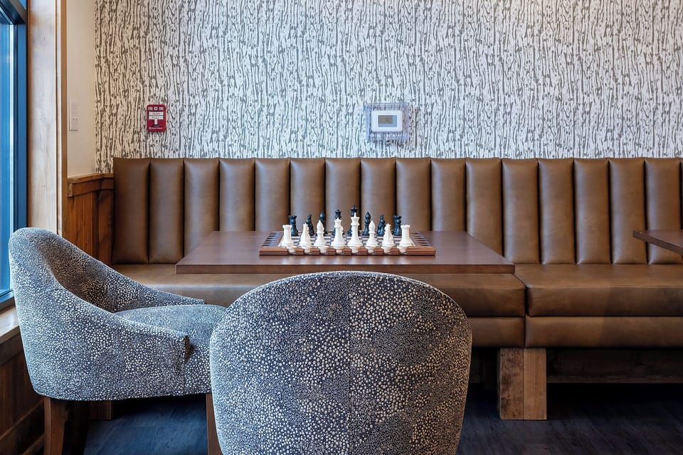 Challenge your travel companion to a game of chess in this sophisticated lounge area with luxurious seating and elegant design.