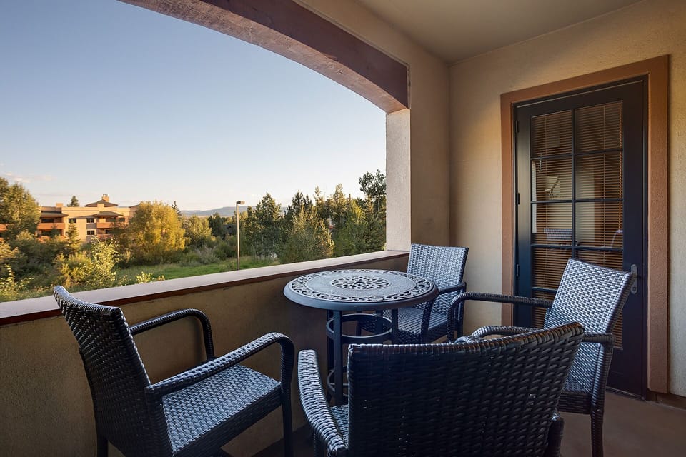 Unwind on your private balcony with comfortable seating and peaceful neighborhood views, perfect for morning coffee or evening relaxation.