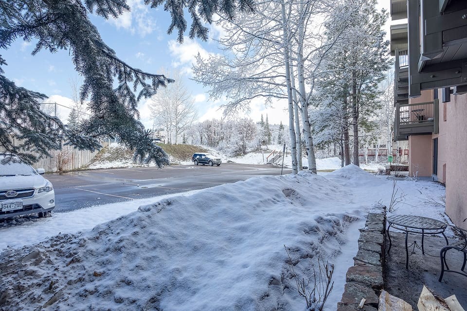Snow-covered property grounds with cleared parking and winter landscape setting.