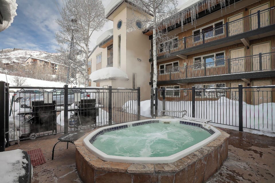 Soak in the bubbling hot tub while snow-capped mountains create your perfect winter backdrop.