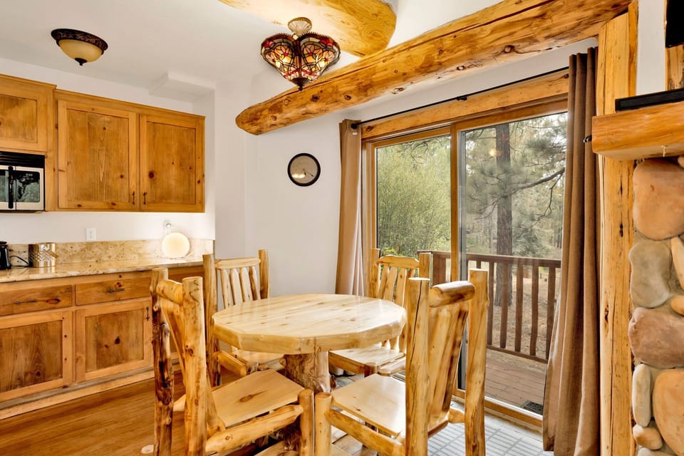 Enjoy your meals at this round wooden dining table, perfectly positioned next to sliding glass doors.