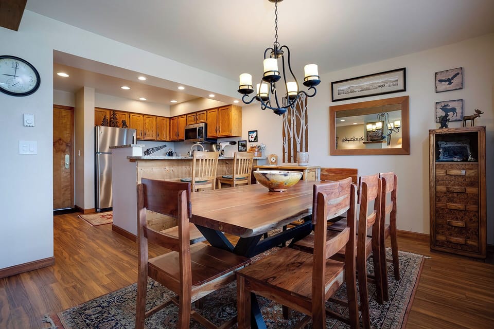 Gather around this beautiful wooden dining table where your group can share meals and make memories together in this cozy, well-appointed space.
