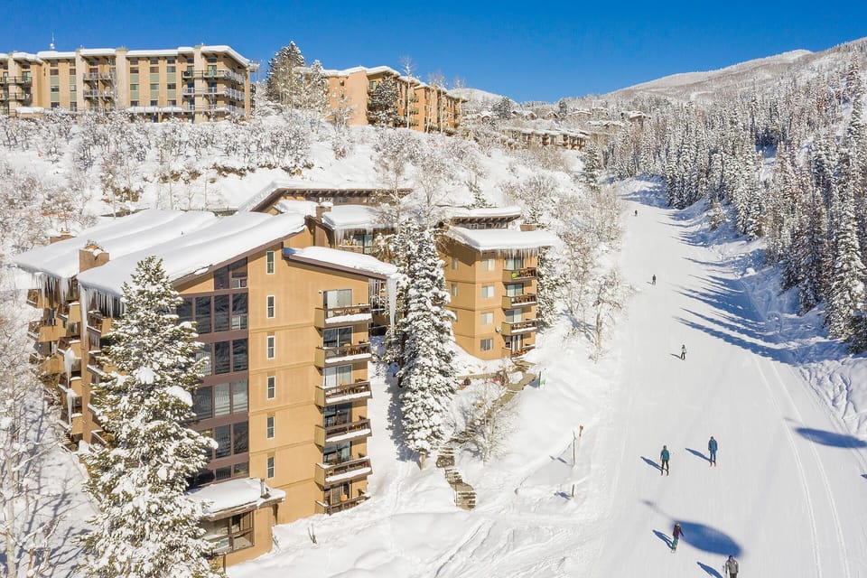 Ski resort community nestled in snow-covered mountains with direct slope access and winter recreation opportunities.