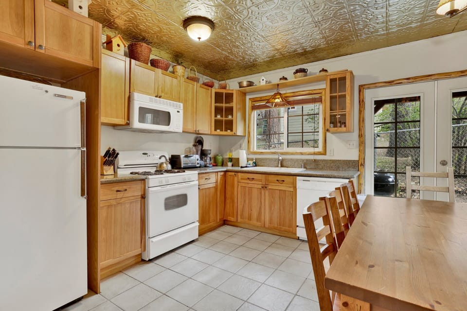 Fully equipped cabin kitchen with ample cabinetry, stove, fridge, and coffee maker—perfect for cooking meals, morning coffee, and feeling right at home on your stay.