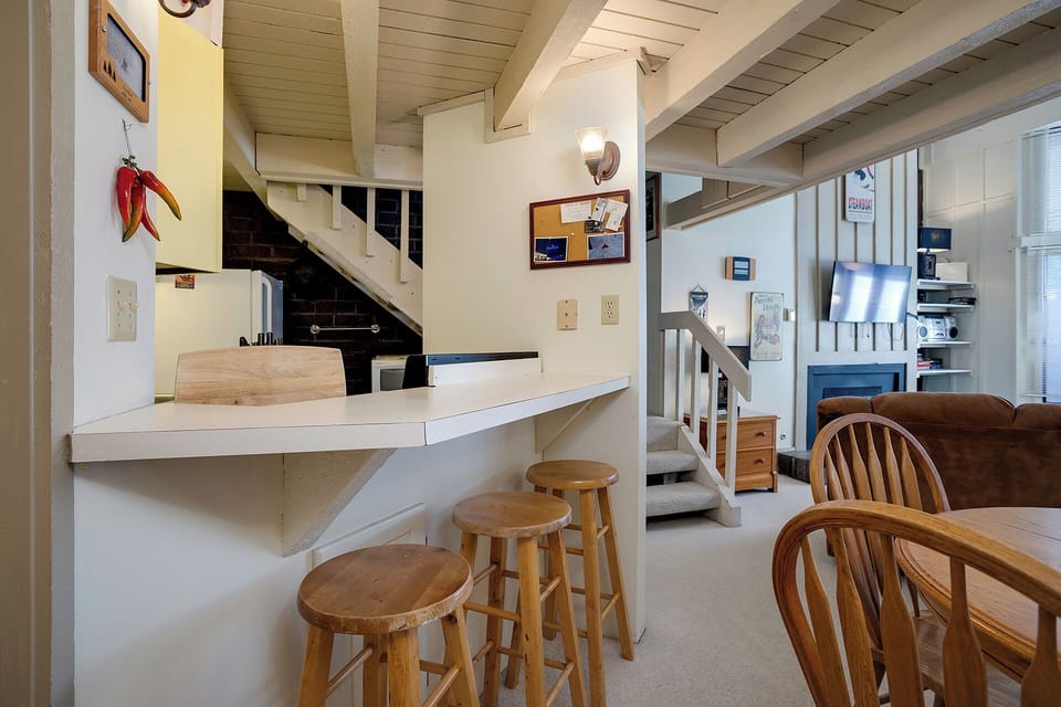 Your cozy kitchen features warm wood details and a convenient breakfast bar where you can enjoy morning coffee or casual meals.