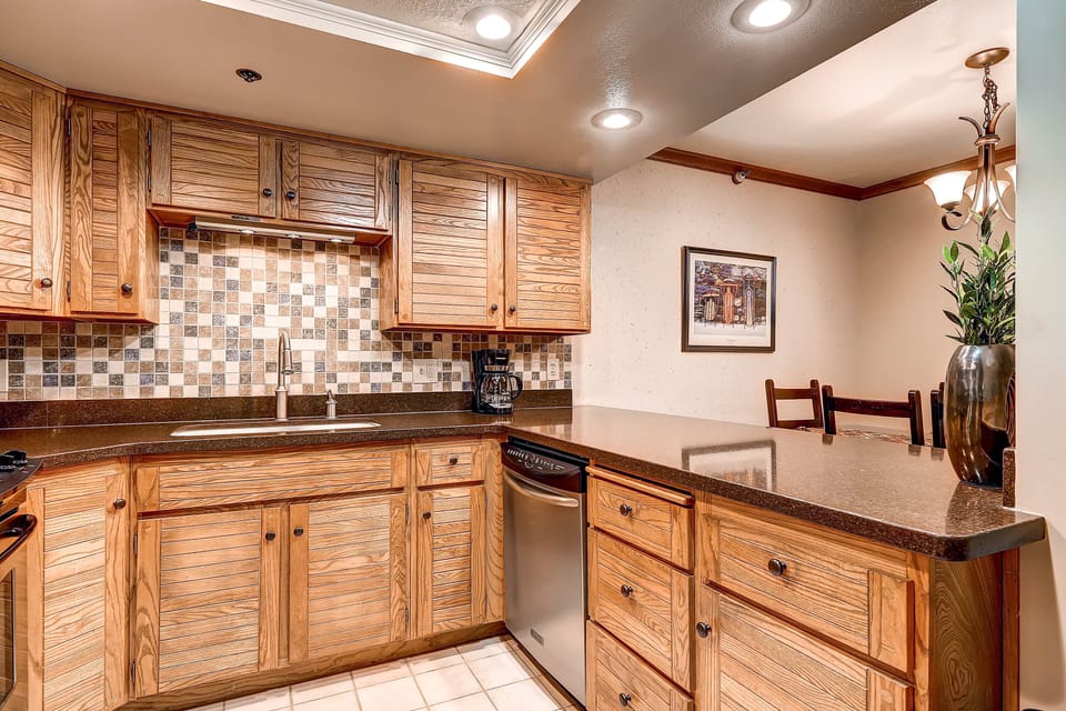 The well-equipped kitchen offers stainless steel appliances and wood cabinets.