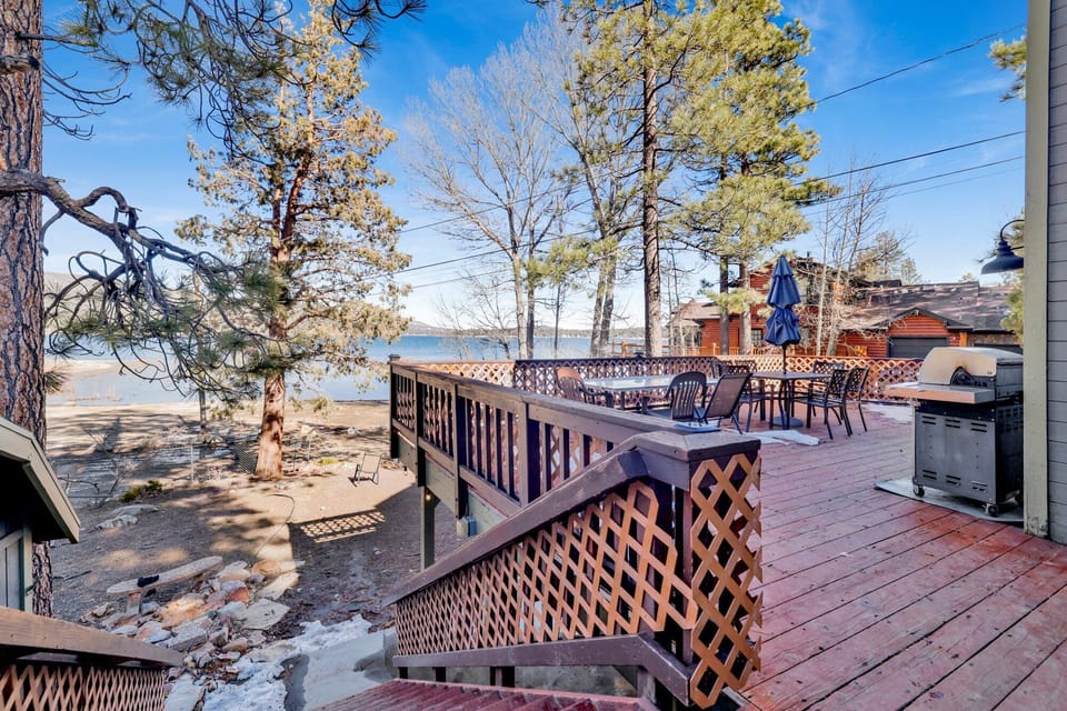Spacious cabin deck with outdoor dining, BBQ grill, and forest views—ideal for al fresco meals, sunset gatherings, and relaxed mountain living year-round.