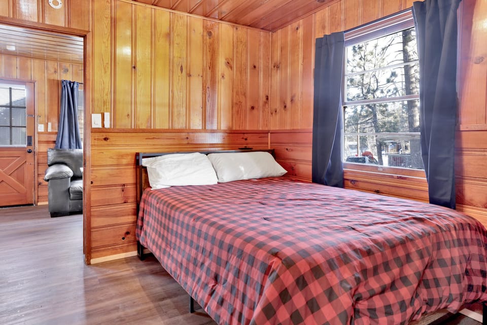 A full size bed with a TV to enjoy a movie night.