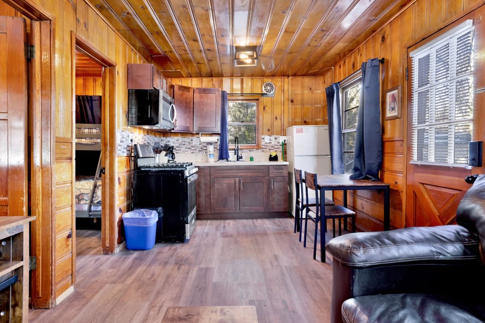 Kitchen with a refrigerator, stove, microwave, oven,coffee machine, and a dining table to enjoy a delicious meal.