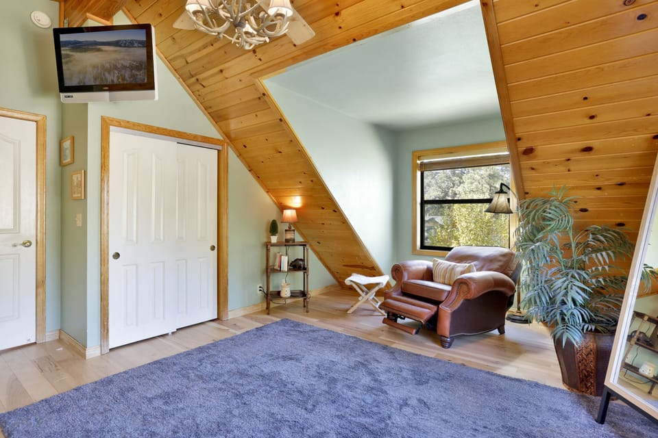 Peaceful cabin bedroom with plush bedding, and beautiful views—ideal for restful nights, cozy mornings, and a relaxing mountain escape.